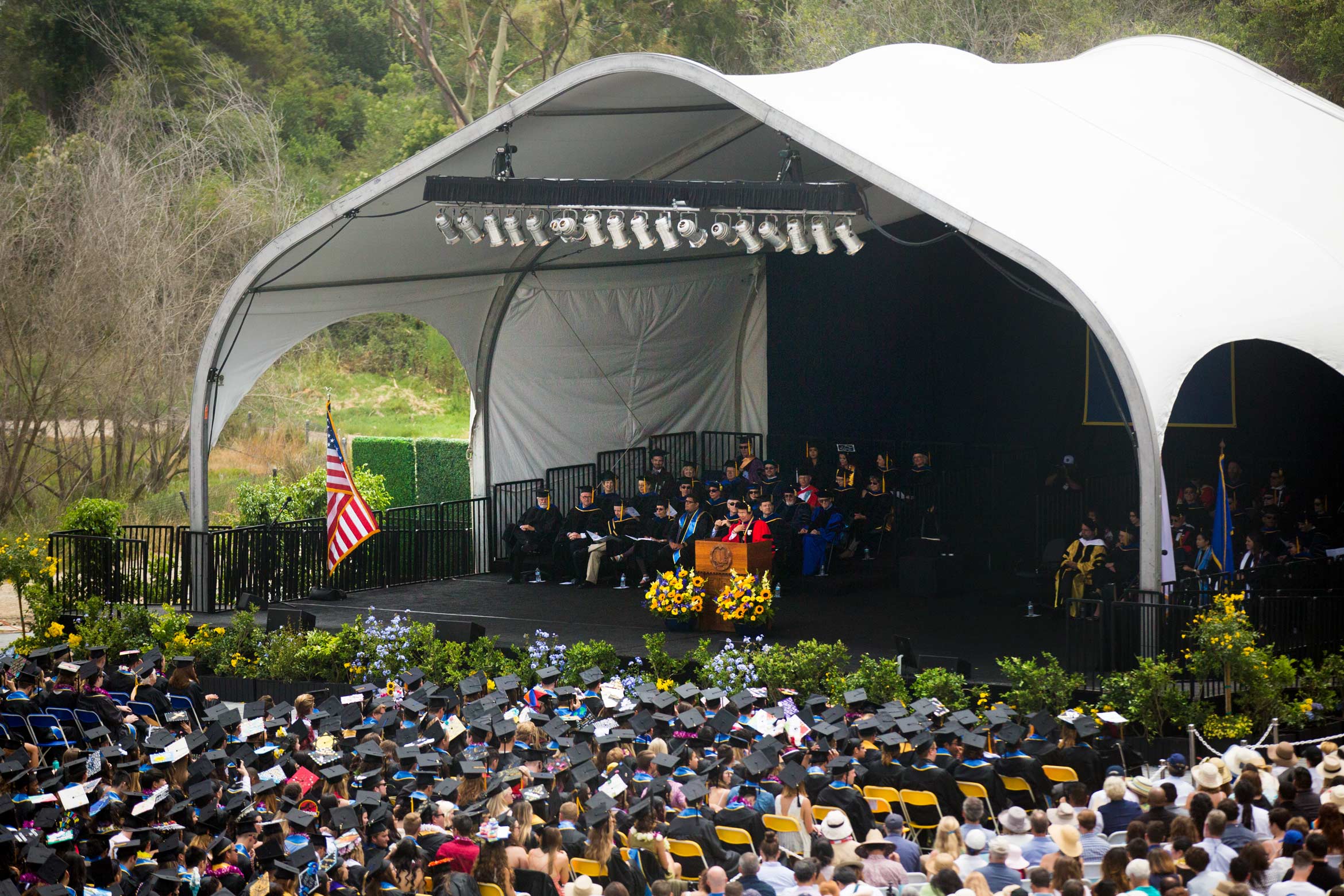 Commencement stage filled with students and faculty